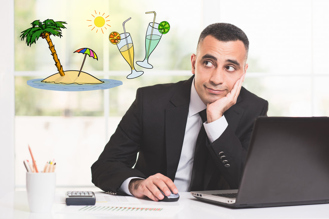 Man at office desk working and daydreaming about a tropical cruise vacation.