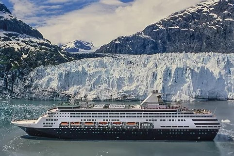 Holland America cruise ship near glacier during an Alaska cruise.